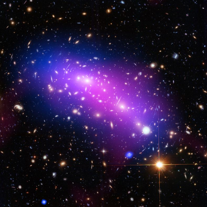 乍一看，这个紫色、蓝色、粉色组成的宇宙万花筒呈现了一个美丽、宁静的太空图景。但实际上，这些朦胧的色块标记了两个星系团相互碰撞的区域，它们正合二为一，形成编号为MACS J0416.1-2403的星系团